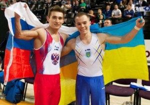 Oleg Verniaiev (UKR) David Belyavskiy (RUS) hugging and holding up the Russian and Ukranian flags