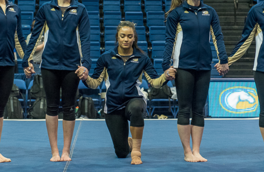 gymnast kneels in protest of police brutality while competing for UC Davis gymnastics team