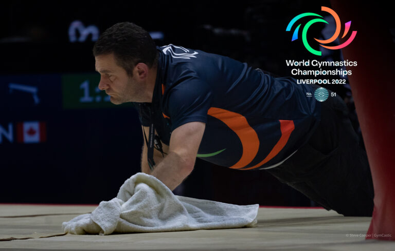 Drying the floor under the balance beam during Women's Team finals at the 2022 World Championships